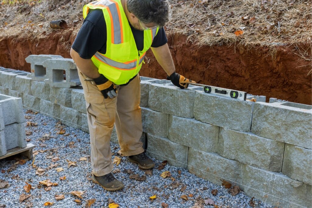 man looking with a tool if the wall is straight